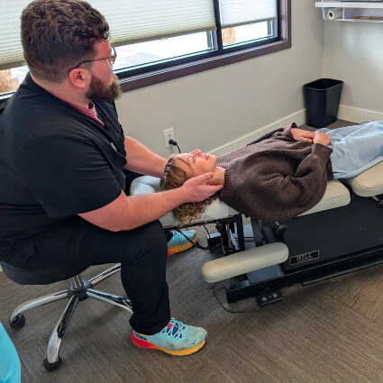 Dr. Brad adjusting patient on table